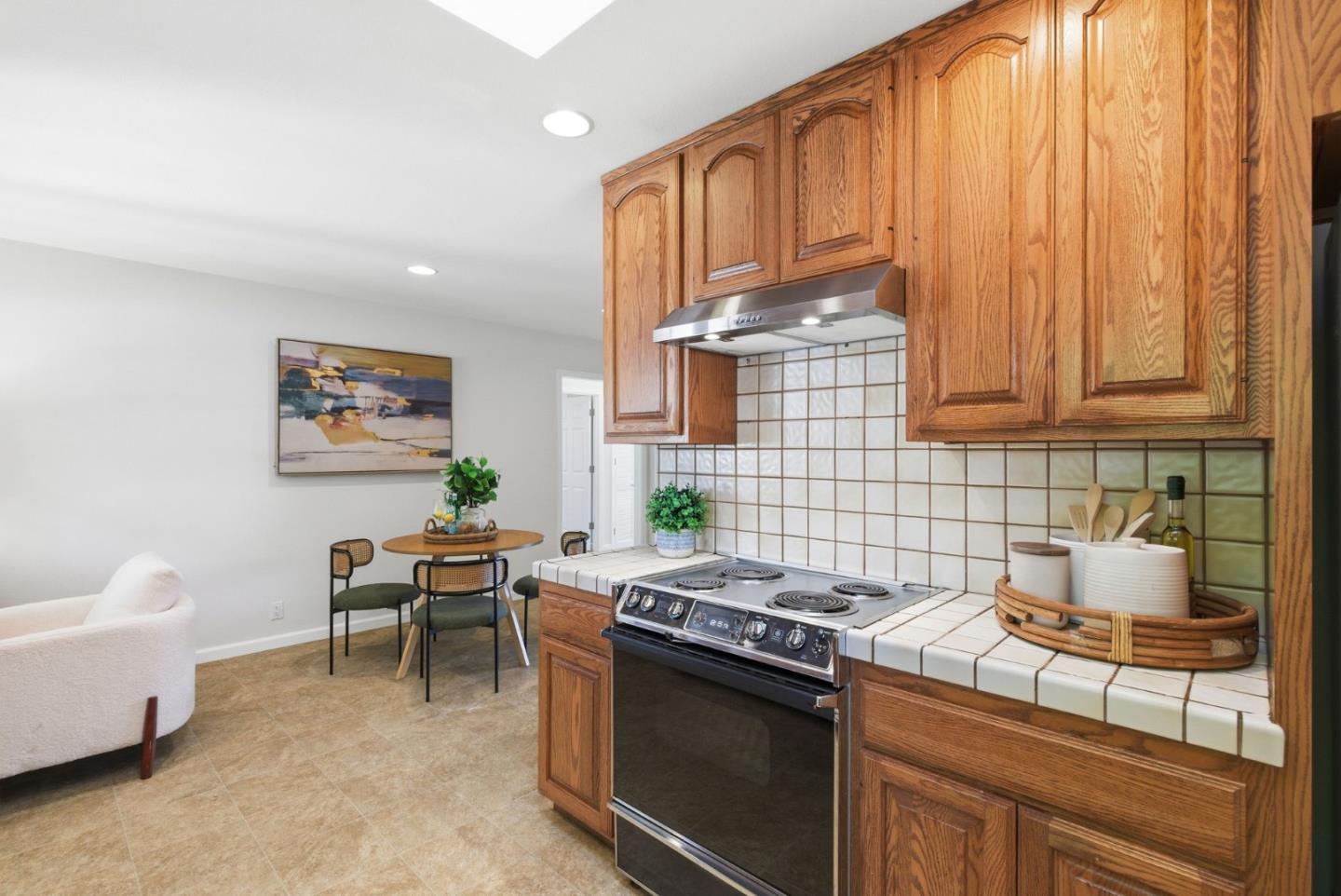 1747 Walnut Drive Mountain View, CA 94040 - Photo 17 of 38 a kitchen with stainless steel appliances granite countertop a stove a sink and a microwave