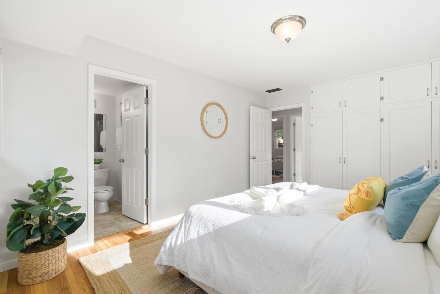 1747 Walnut Drive Mountain View, CA 94040 - Photo 24 of 38 a bedroom with a bed and a potted plant
