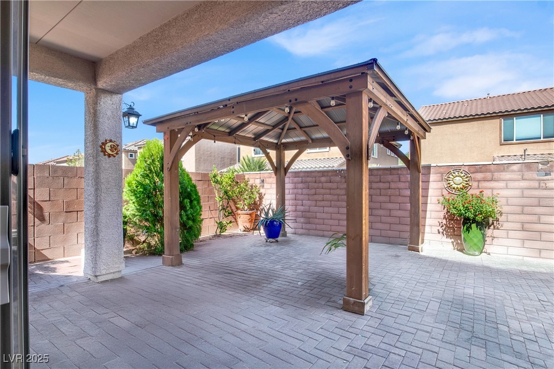 10976 Bluebell Basin Road Las Vegas, NV 89179 - Photo 16 of 40 Fenced backyard featuring a gazebo and a patio area