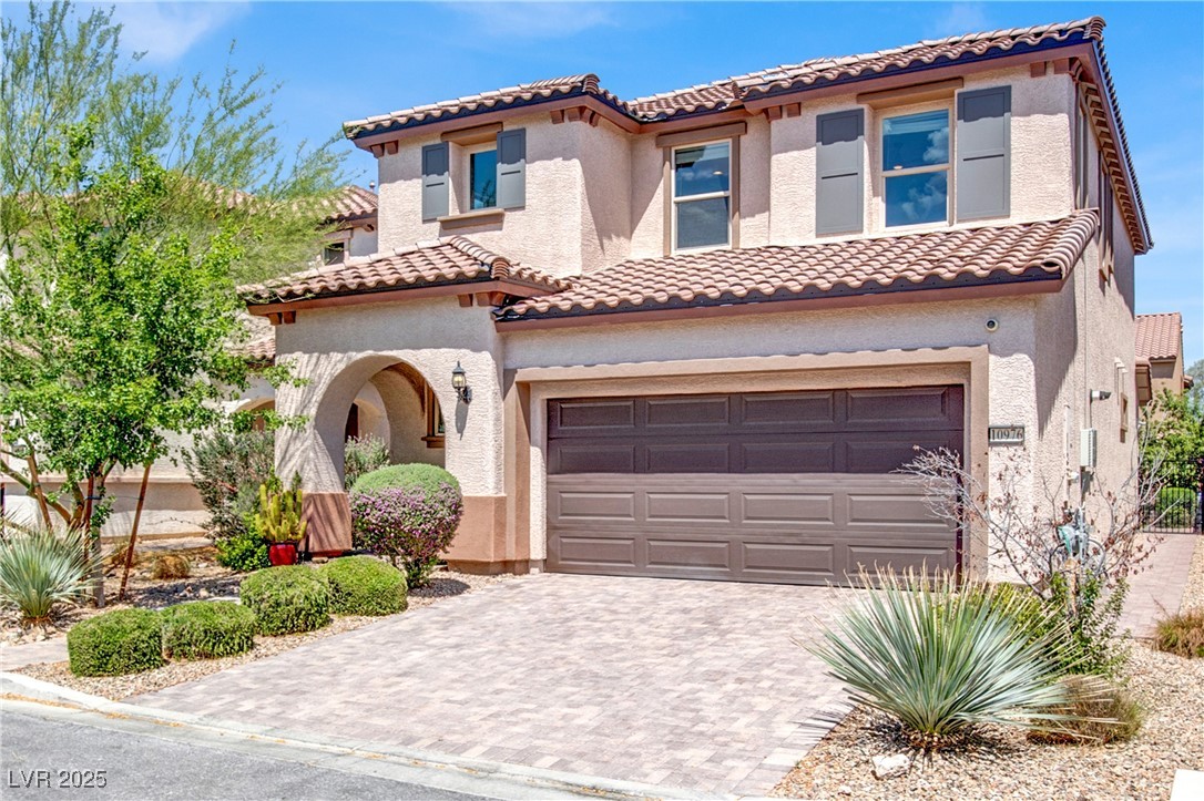 10976 Bluebell Basin Road Las Vegas, NV 89179 - Photo 2 of 40 Mediterranean / spanish home featuring a tile roof, a garage, driveway, and stucco siding