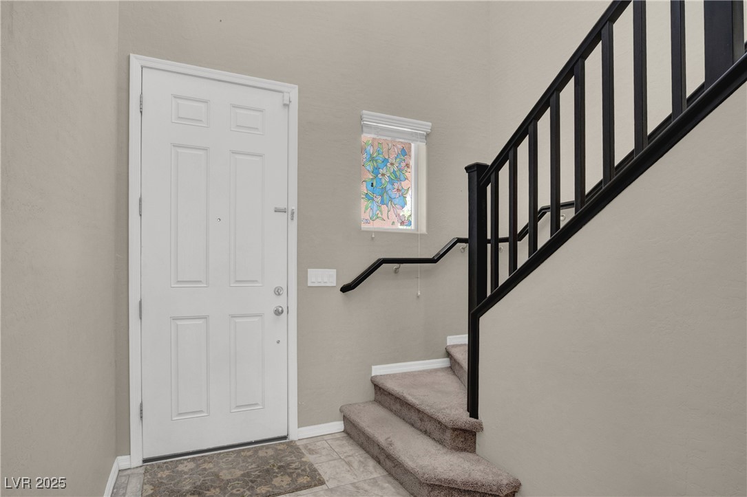 10976 Bluebell Basin Road Las Vegas, NV 89179 - Photo 22 of 40 Entrance foyer featuring stairway and baseboards