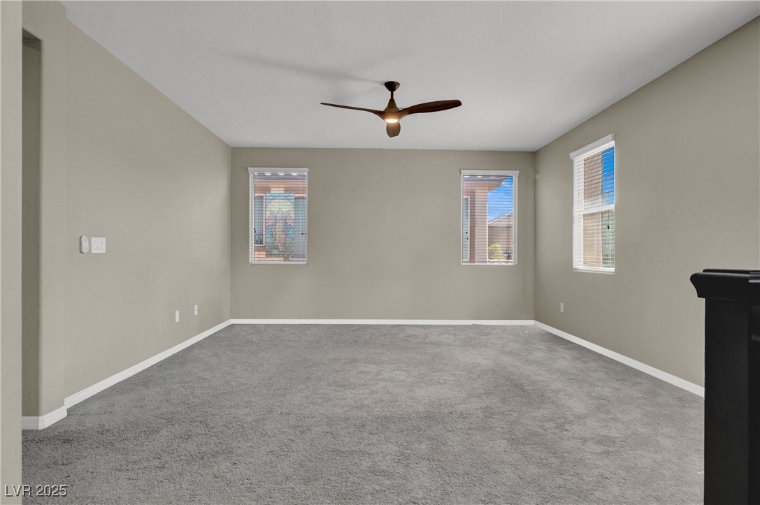 10976 Bluebell Basin Road Las Vegas, NV 89179 - Photo 23 of 40 Spare room with a ceiling fan, plenty of natural light, carpet, and baseboards