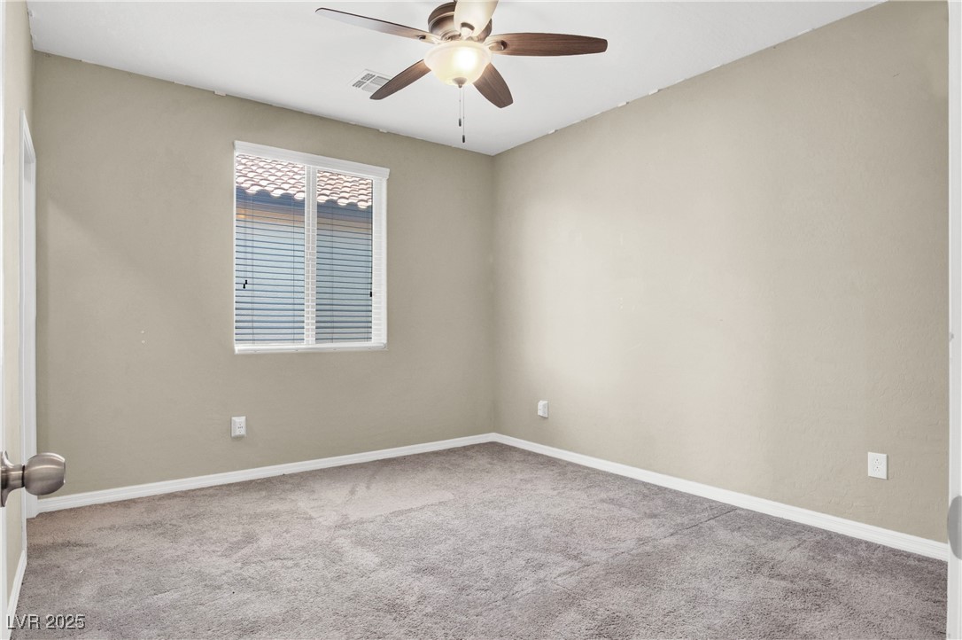 10976 Bluebell Basin Road Las Vegas, NV 89179 - Photo 26 of 40 Carpeted spare room featuring a ceiling fan and baseboards