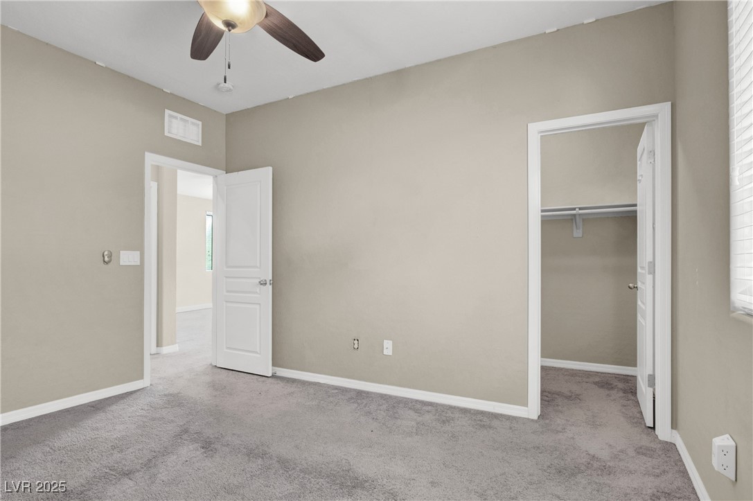10976 Bluebell Basin Road Las Vegas, NV 89179 - Photo 28 of 40 Unfurnished bedroom featuring carpet, a spacious closet, and baseboards