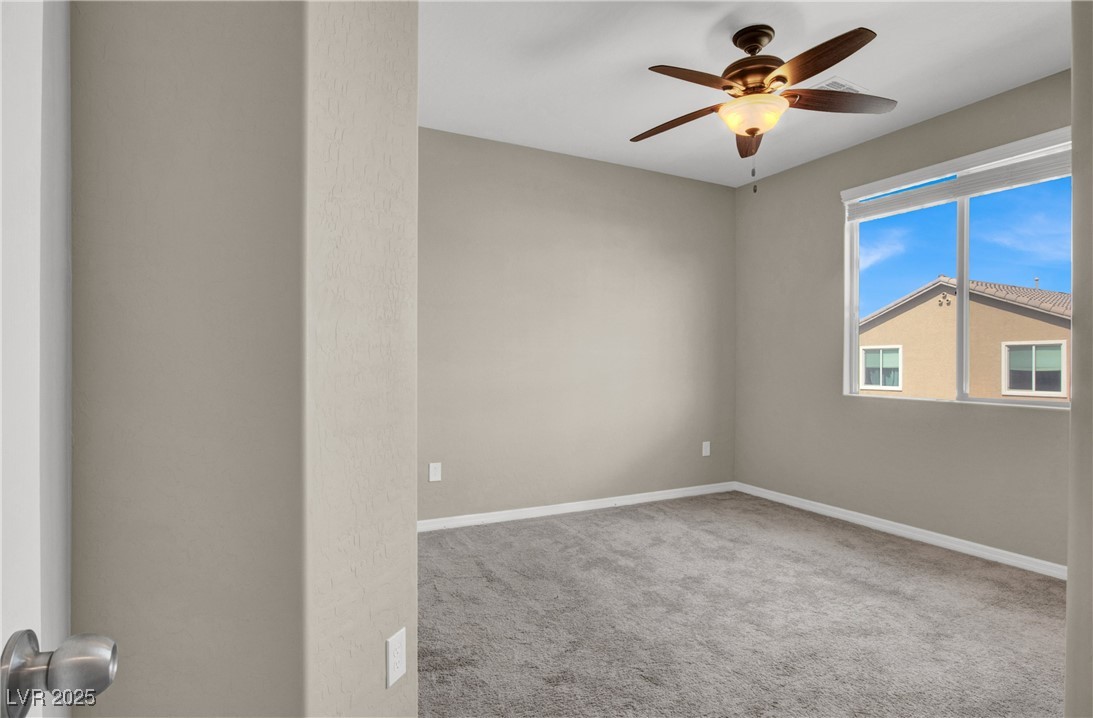 10976 Bluebell Basin Road Las Vegas, NV 89179 - Photo 31 of 40 Empty room with ceiling fan, carpet floors, and baseboards