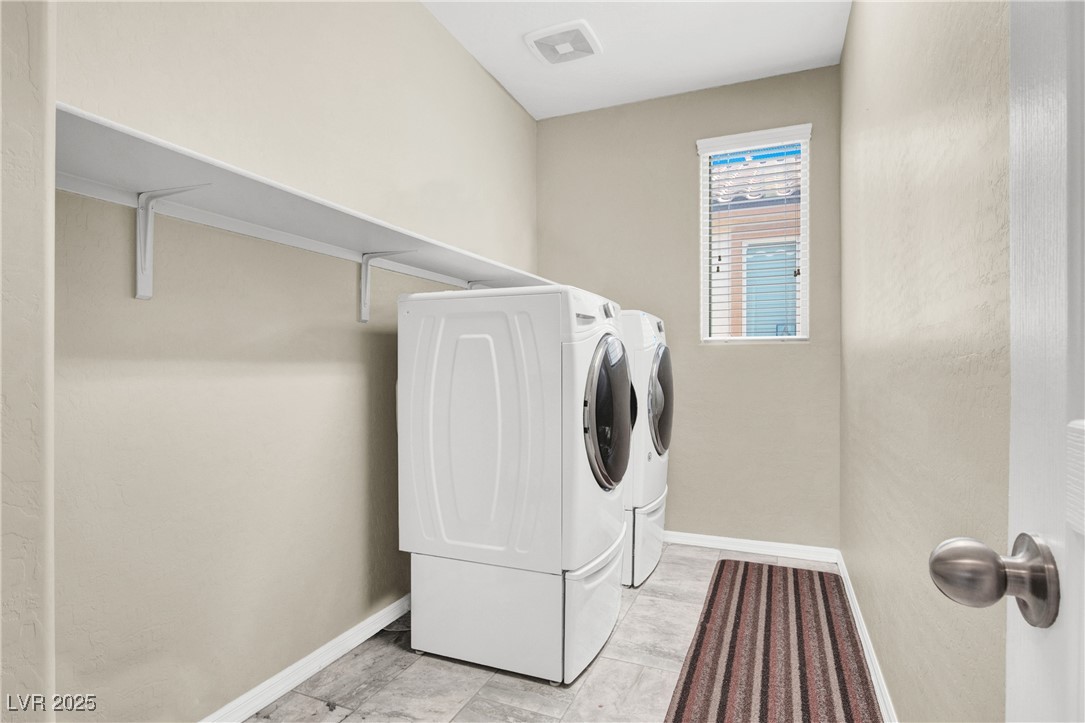 10976 Bluebell Basin Road Las Vegas, NV 89179 - Photo 34 of 40 Washroom featuring washer and dryer and baseboards
