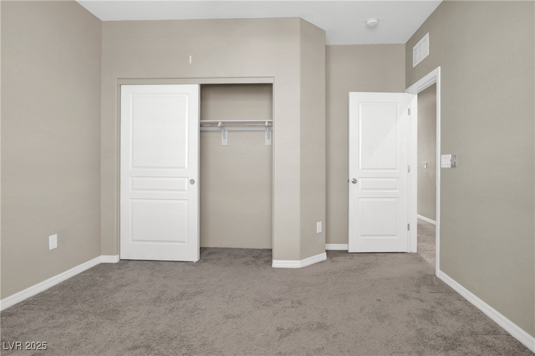 10976 Bluebell Basin Road Las Vegas, NV 89179 - Photo 36 of 40 Unfurnished bedroom with carpet, a closet, and baseboards