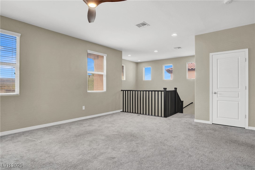 10976 Bluebell Basin Road Las Vegas, NV 89179 - Photo 37 of 40 Carpeted spare room featuring baseboards, a ceiling fan, and recessed lighting