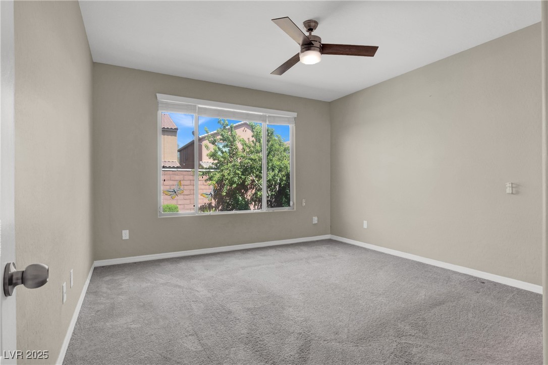 10976 Bluebell Basin Road Las Vegas, NV 89179 - Photo 9 of 40 Carpeted empty room with a ceiling fan and baseboards