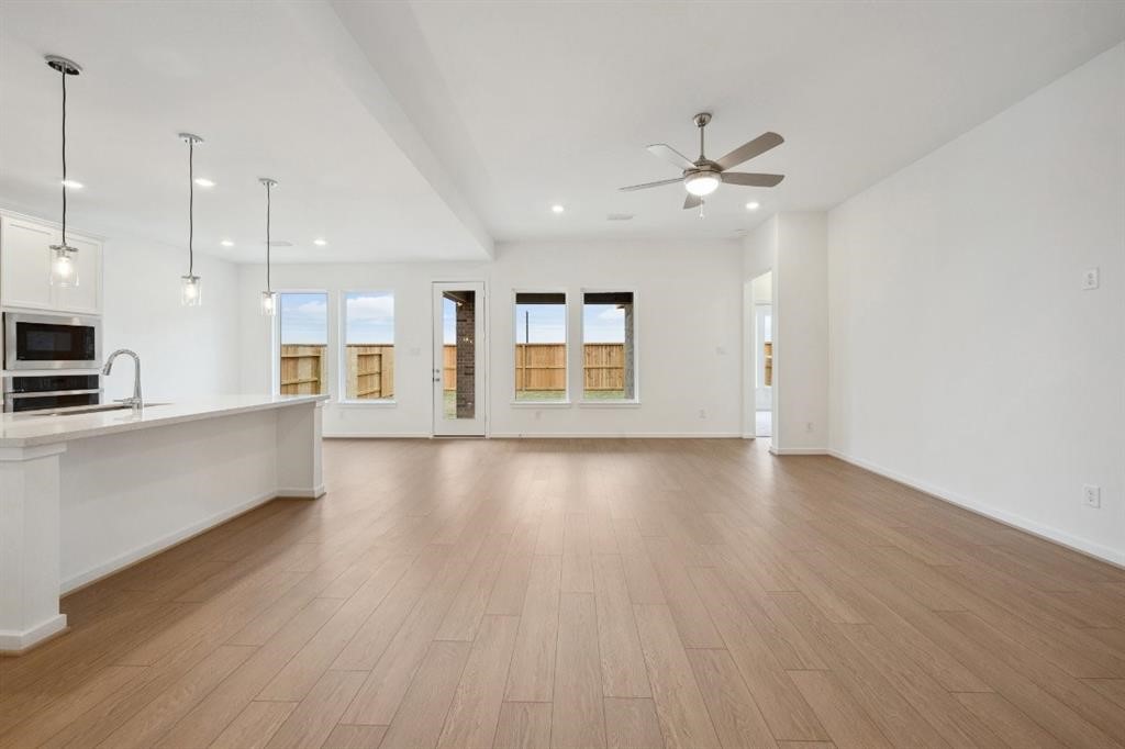 21918 Wycombe Terrace Way Cypress, TX 77433 - Photo 1 of 43 a view of an empty room with window and wooden floor