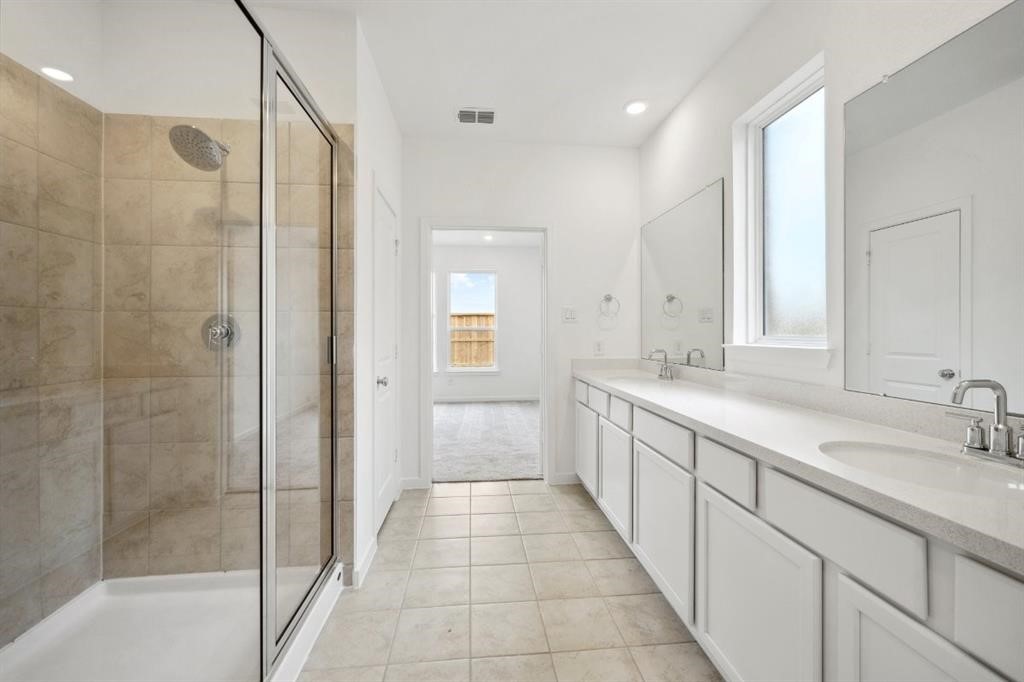 21918 Wycombe Terrace Way Cypress, TX 77433 - Photo 14 of 43 a large bathroom with a granite countertop sink a mirror and a shower