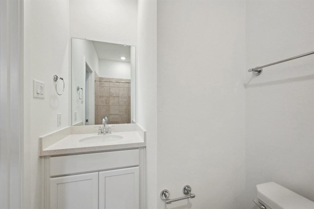 21918 Wycombe Terrace Way Cypress, TX 77433 - Photo 26 of 43 a bathroom with a sink a toilet and a mirror