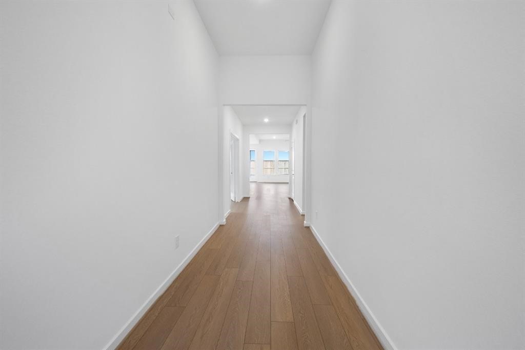 21918 Wycombe Terrace Way Cypress, TX 77433 - Photo 28 of 43 a view of a hallway with wooden floor