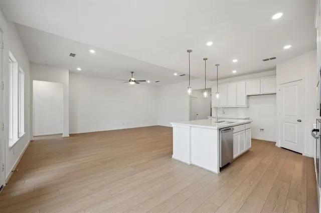 a view of a kitchen with a sink and a refrigerator