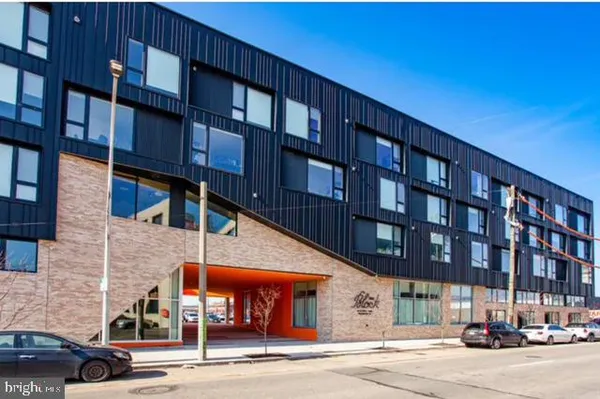 a view of building with car parked