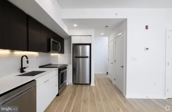 a kitchen with a sink appliances and cabinets
