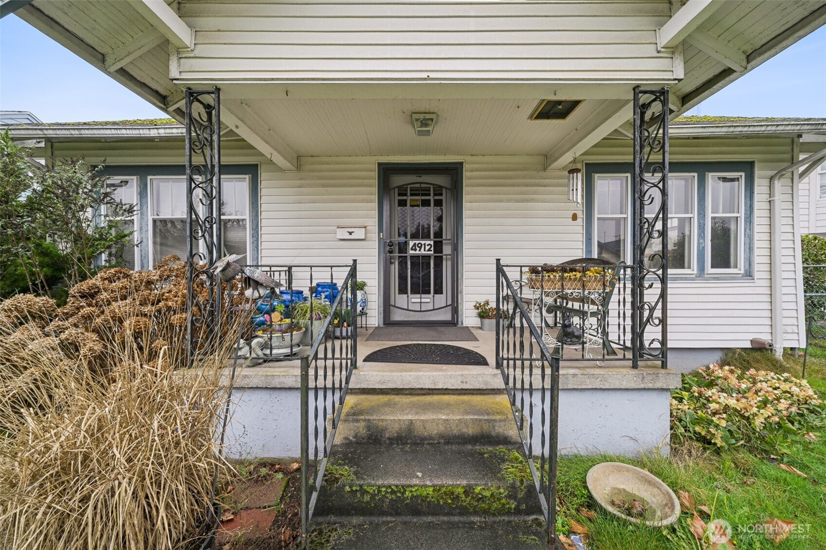 4912 South Prospect Street Tacoma, WA 98409 - Photo 2 of 16 a front view of a house with a porch