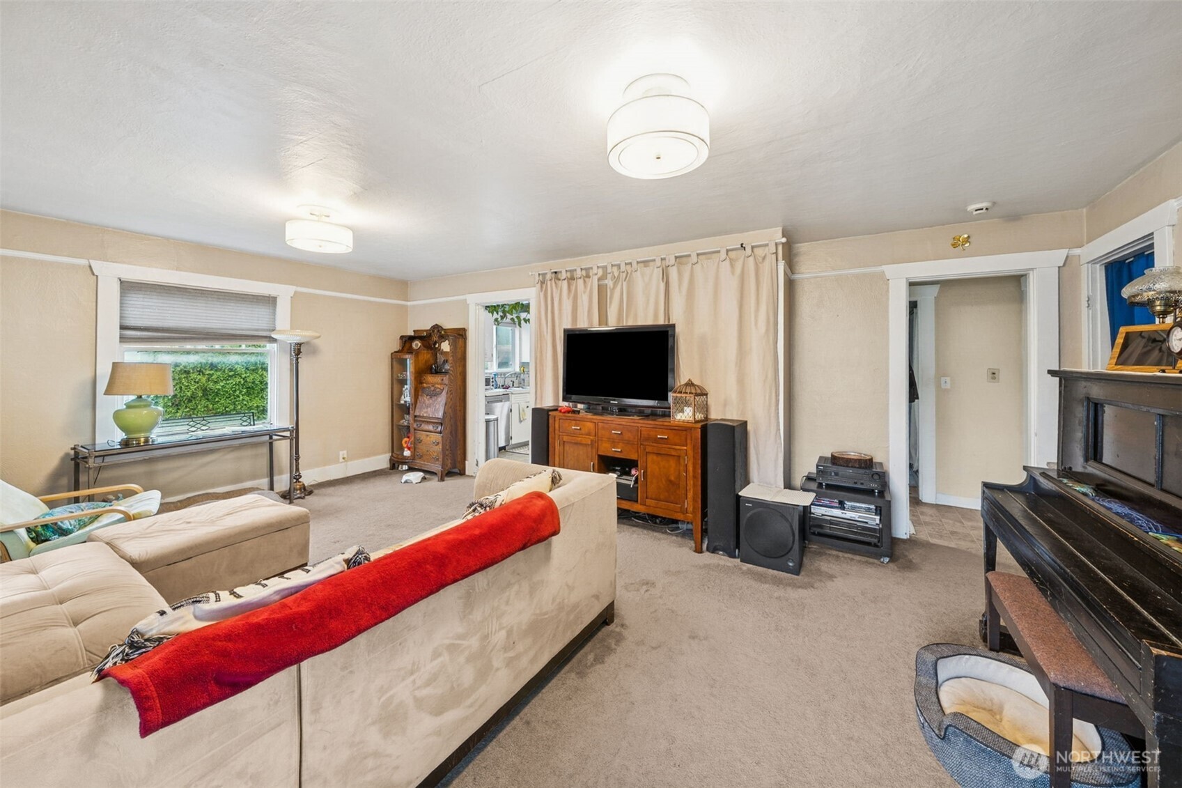 4912 South Prospect Street Tacoma, WA 98409 - Photo 3 of 16 a living room with furniture and a flat screen tv