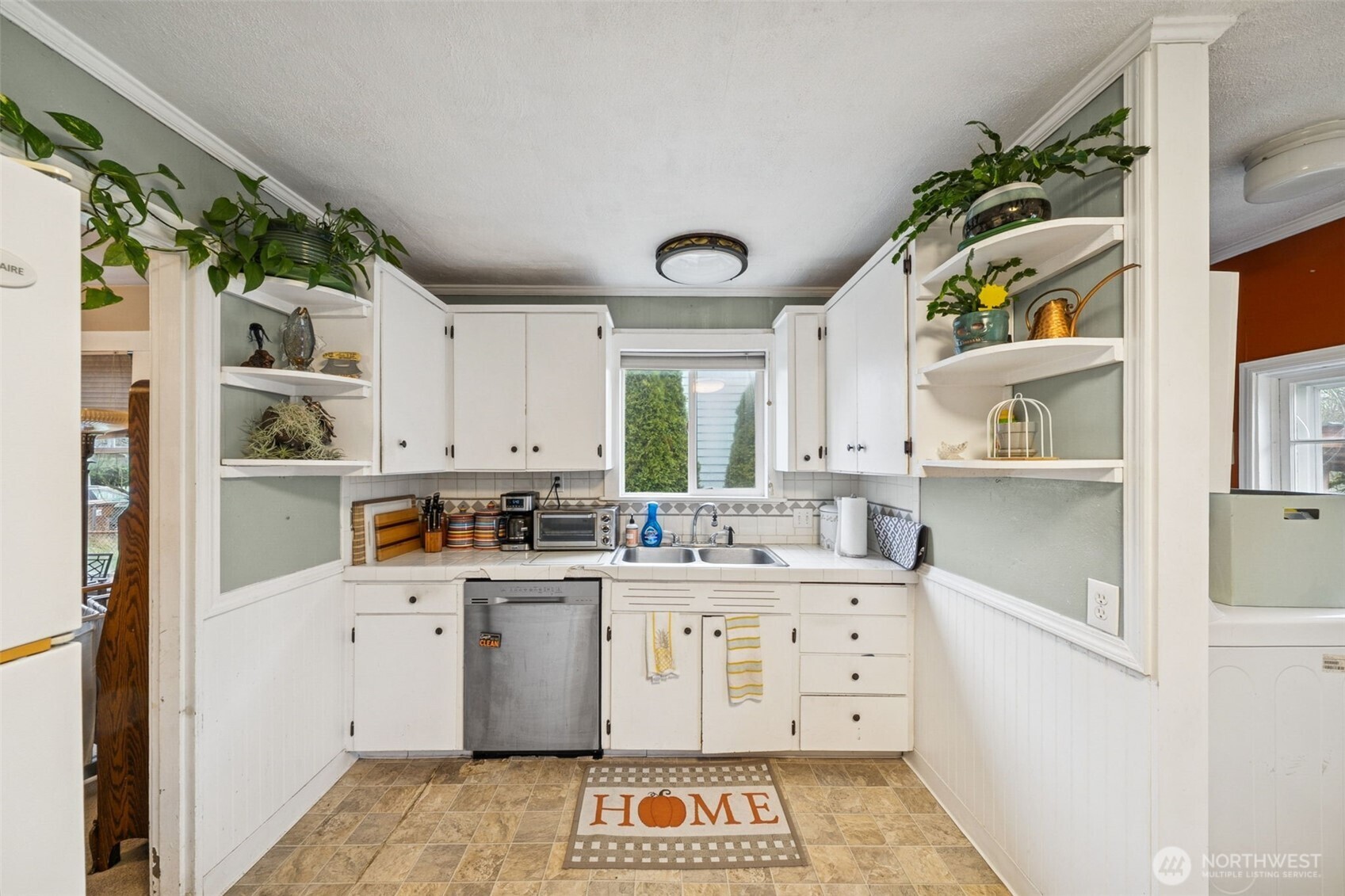 4912 South Prospect Street Tacoma, WA 98409 - Photo 6 of 16 a large white kitchen with a lot of white cabinets