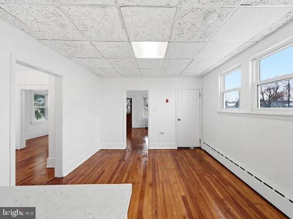 a view of a room with wooden floor and window