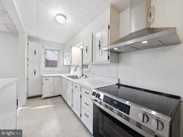 a kitchen with a stove and a sink