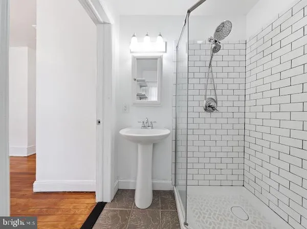 a bathroom with a sink a shower and a mirror