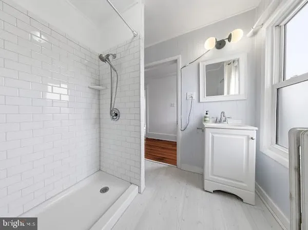 a bathroom with a shower and a sink