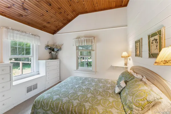 a bed sitting in a bedroom next to a window