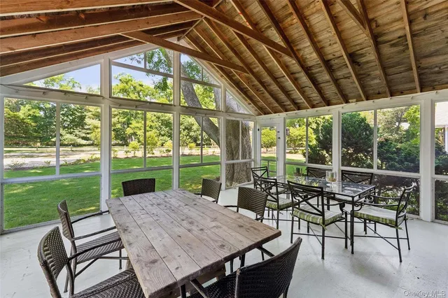 a view of a patio with a table chairs and a backyard