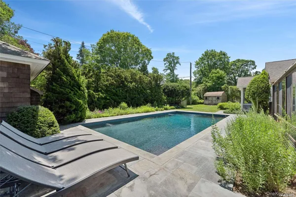 a view of a backyard with plants and outdoor seating