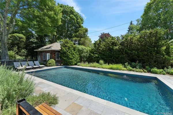 a view of a house with backyard sitting area and garden