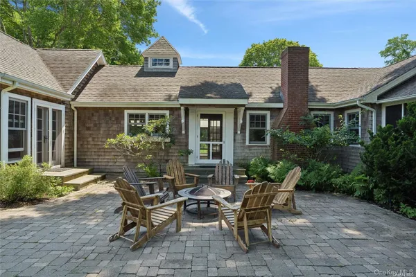 a view of a patio with couple of chairs and a table