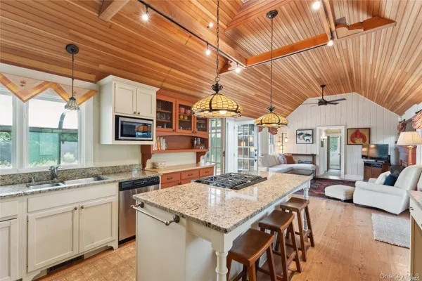 a kitchen with a table chairs and a wooden floor