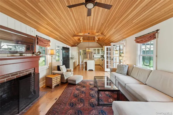 a living room with furniture a table and a fireplace