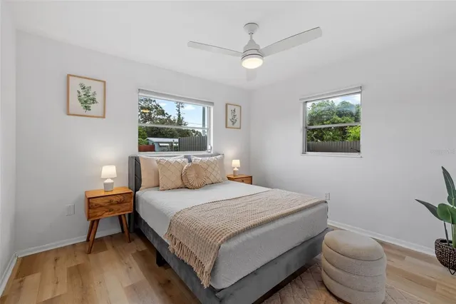 a bedroom with a bed and a painting on the wall