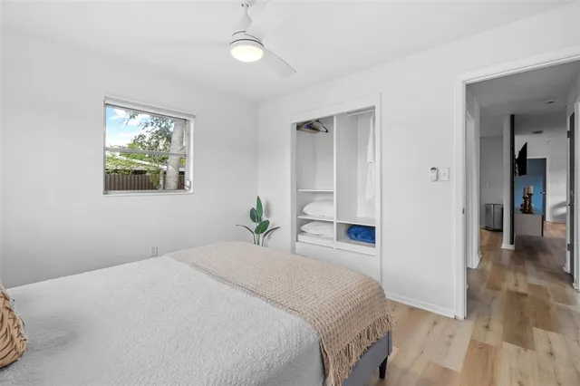 a bedroom with a bed and a window