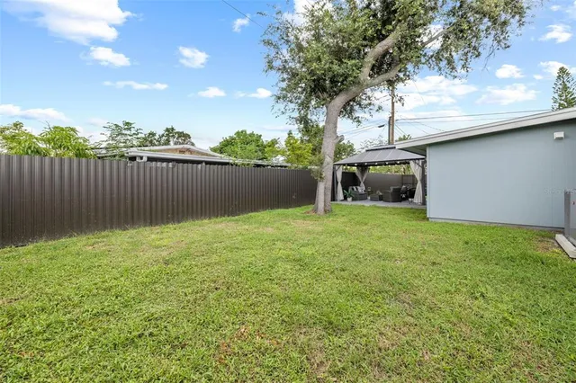 a backyard of a house with lots of green space