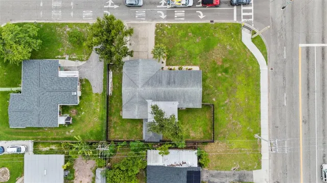 an aerial view of a house with a garden and swimming pool