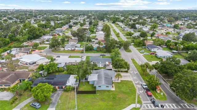 an aerial view of residential houses with outdoor space and swimming pool