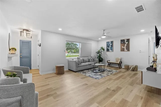 a living room with furniture and wooden floor