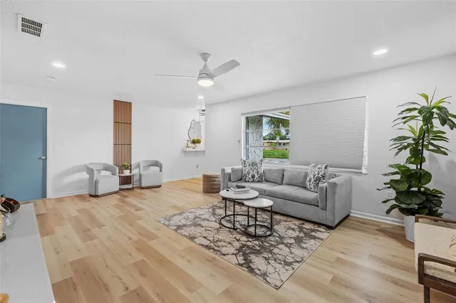 a living room with furniture potted plant and a window