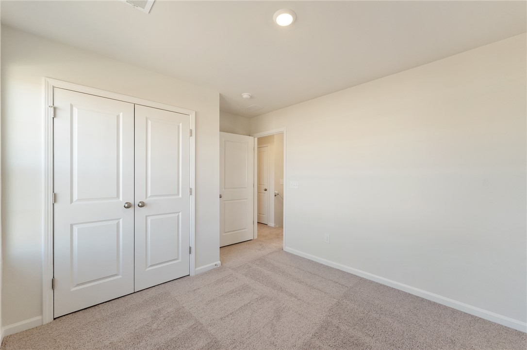 138 Cotesworth Street Pendleton, SC 29670 - Photo 12 of 19 This clean room offers a blank canvas for personalization, featuring soft carpeting and bright recessed lighting.