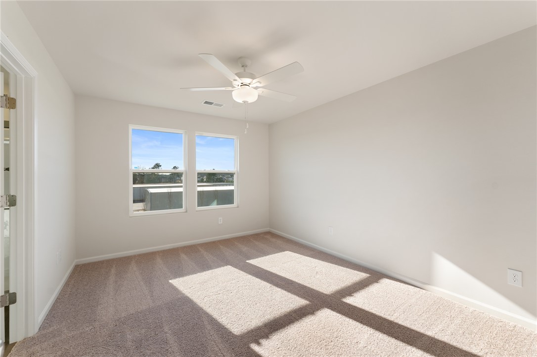 138 Cotesworth Street Pendleton, SC 29670 - Photo 15 of 19 This bright bedroom features ample natural light and plush carpeting, creating a comfortable living space.