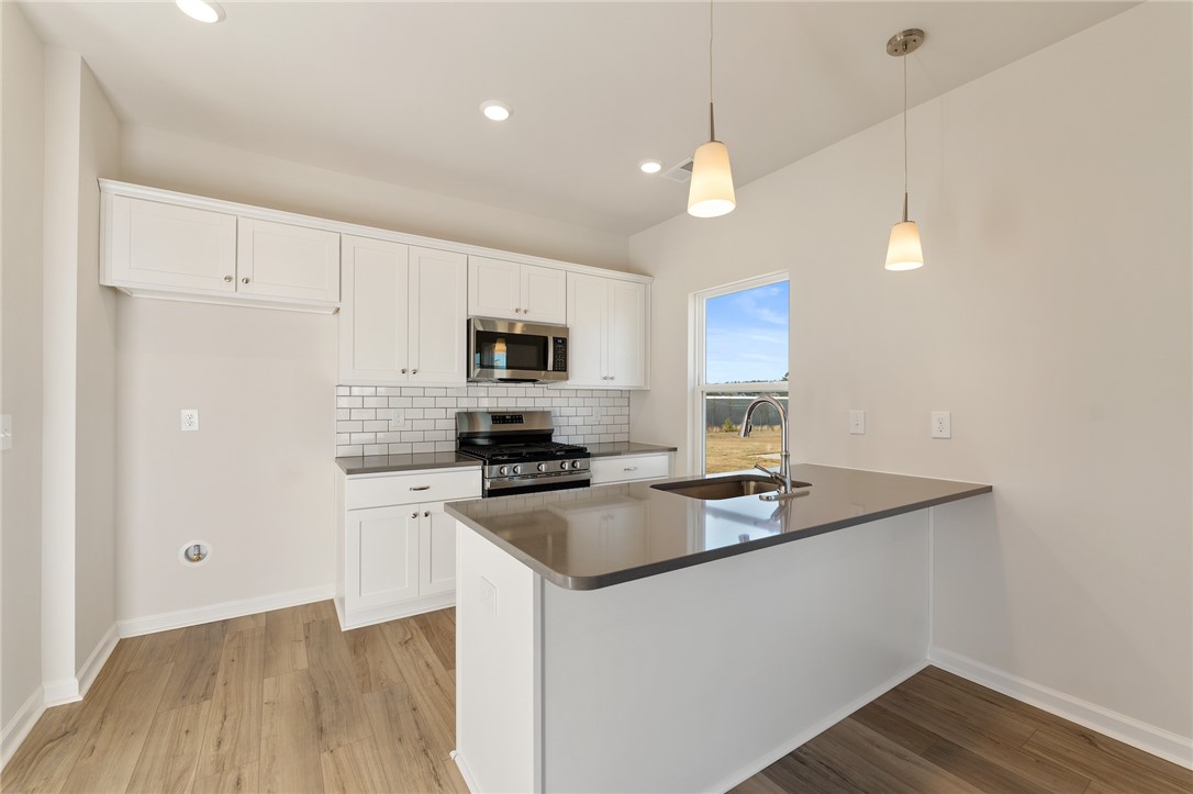 138 Cotesworth Street Pendleton, SC 29670 - Photo 3 of 19 This bright kitchen features sleek countertops, modern appliances, and ample cabinet space.