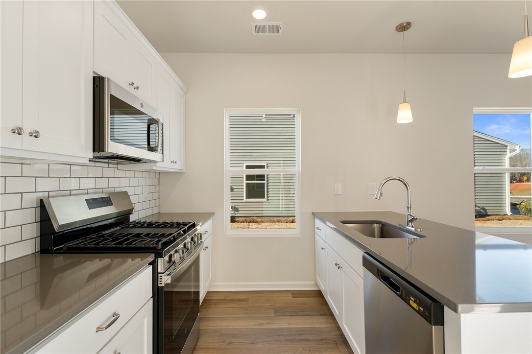 138 Cotesworth Street Pendleton, SC 29670 - Photo 4 of 19 This kitchen features stainless steel appliances, ample counter space, and a bright, inviting atmosphere.