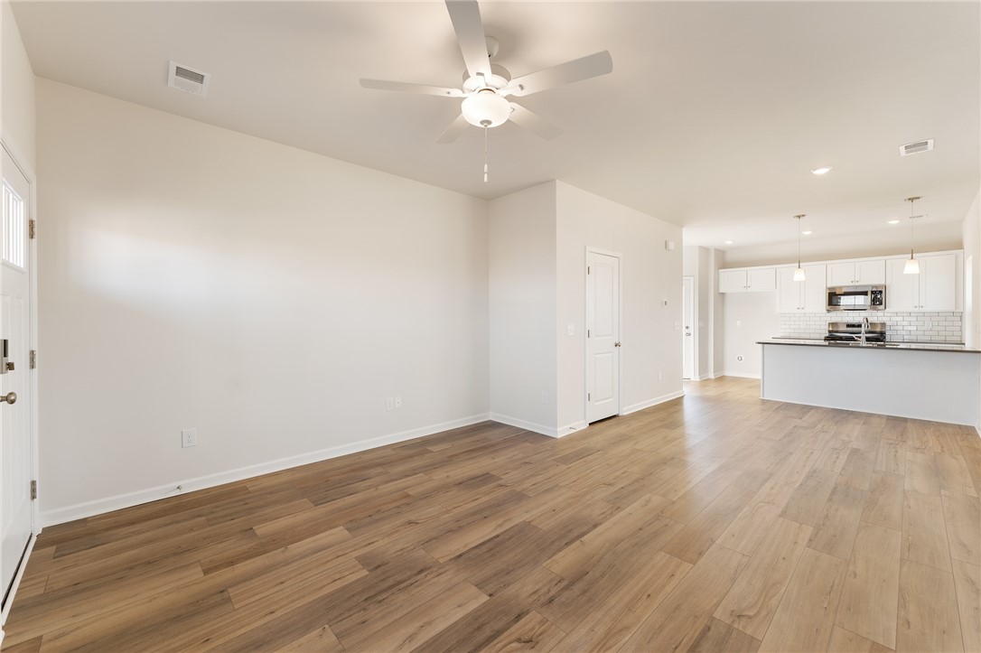 138 Cotesworth Street Pendleton, SC 29670 - Photo 6 of 19 This bright, open-concept living area flows seamlessly into a contemporary kitchen, perfect for modern living.