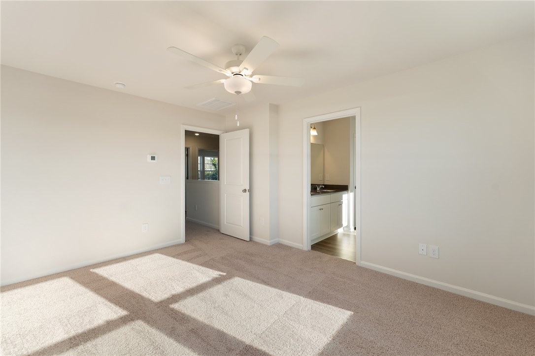 138 Cotesworth Street Pendleton, SC 29670 - Photo 8 of 19 This airy bedroom offers soft carpeting and a ceiling fan, connecting to an adjacent bath.