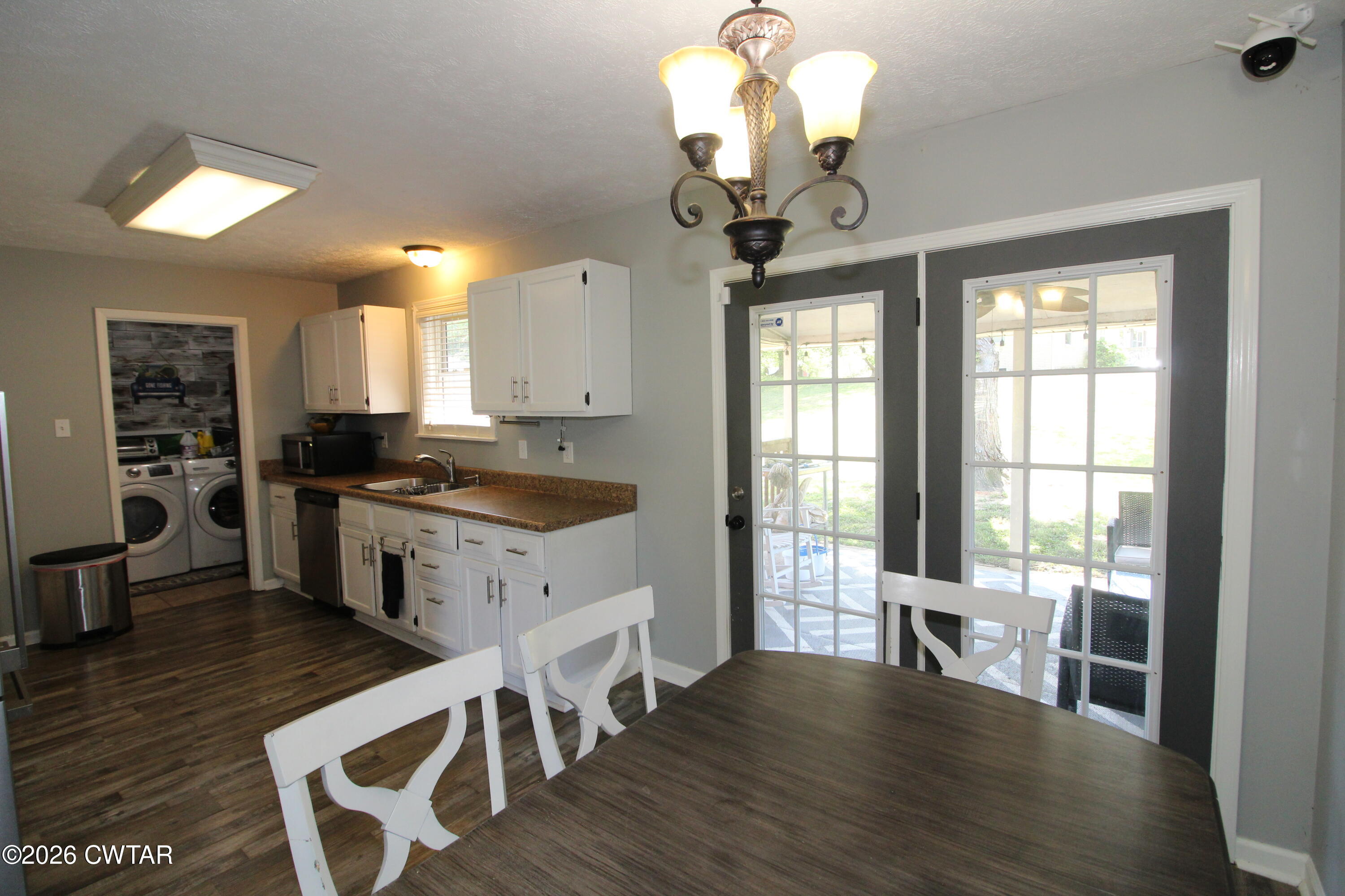 33 Kipling Drive Jackson, TN 38305 - Photo 11 of 20 a kitchen with wooden floors and white cabinets