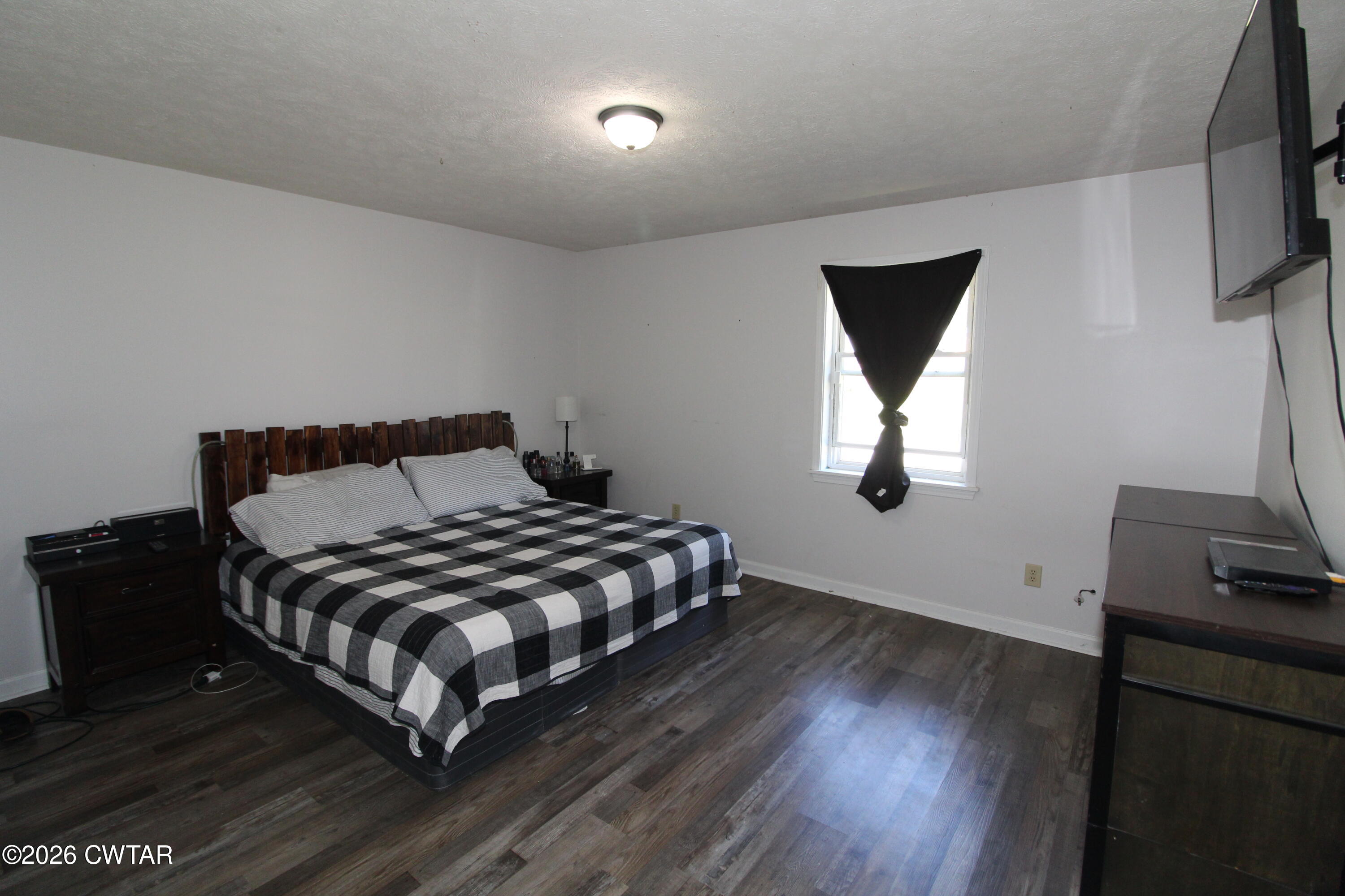 33 Kipling Drive Jackson, TN 38305 - Photo 12 of 20 a bedroom with a bed and a flat tv screen on a dresser