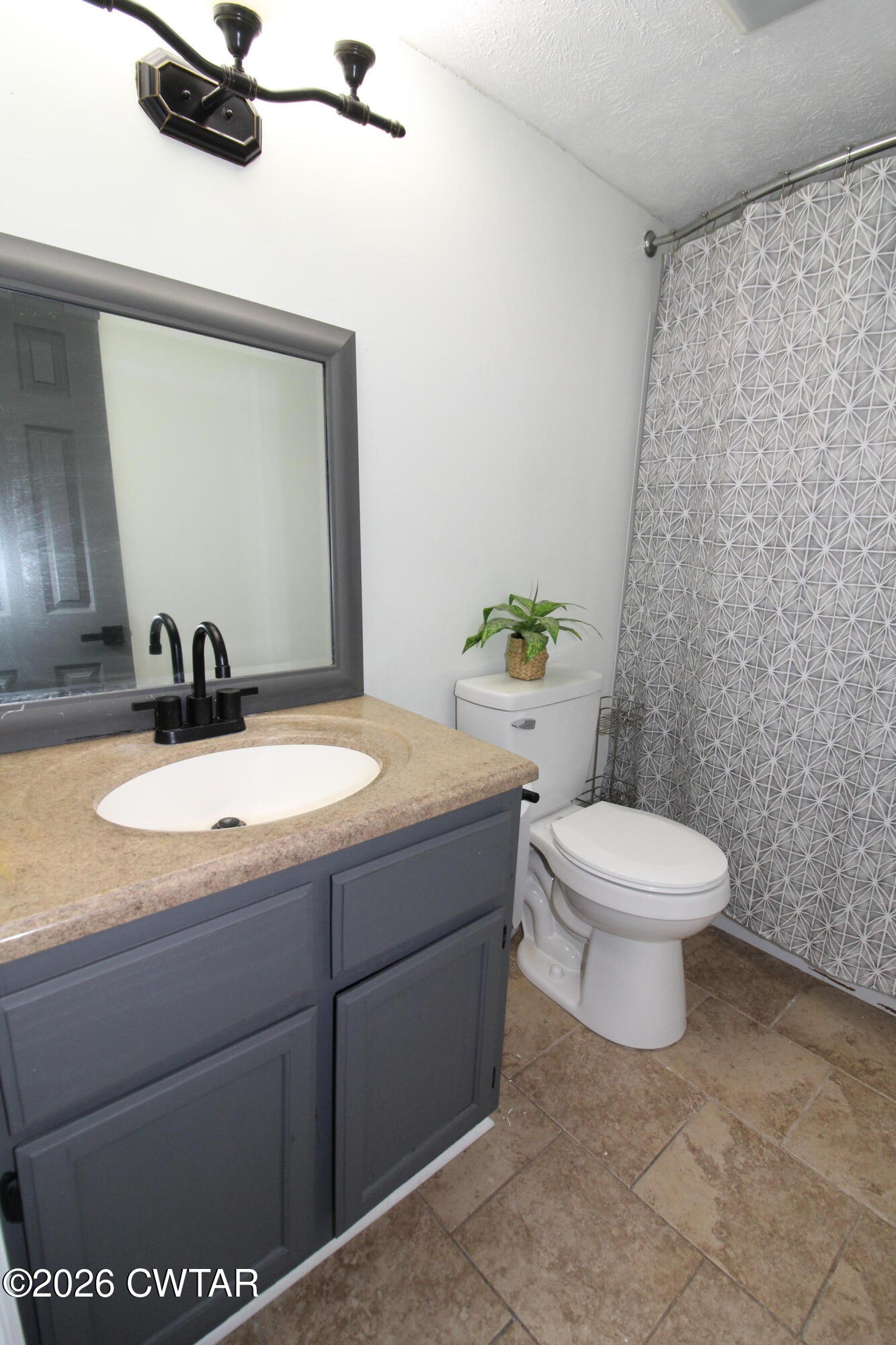 33 Kipling Drive Jackson, TN 38305 - Photo 16 of 20 a bathroom with a granite countertop toilet sink and mirror